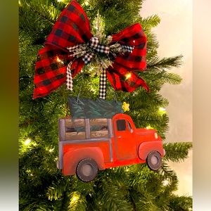Red truck decoration. Painted wood truck attached to buffalo plaid bow on wire.